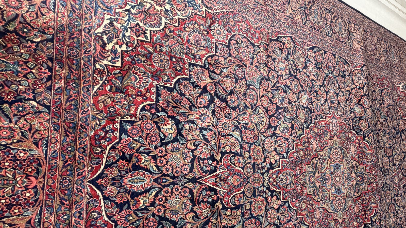 A finished rug rolled at the workshop doors, ready for the Valley collection run